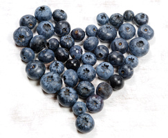 Blaubeeren sind in Form eines Herzens angeordnet.